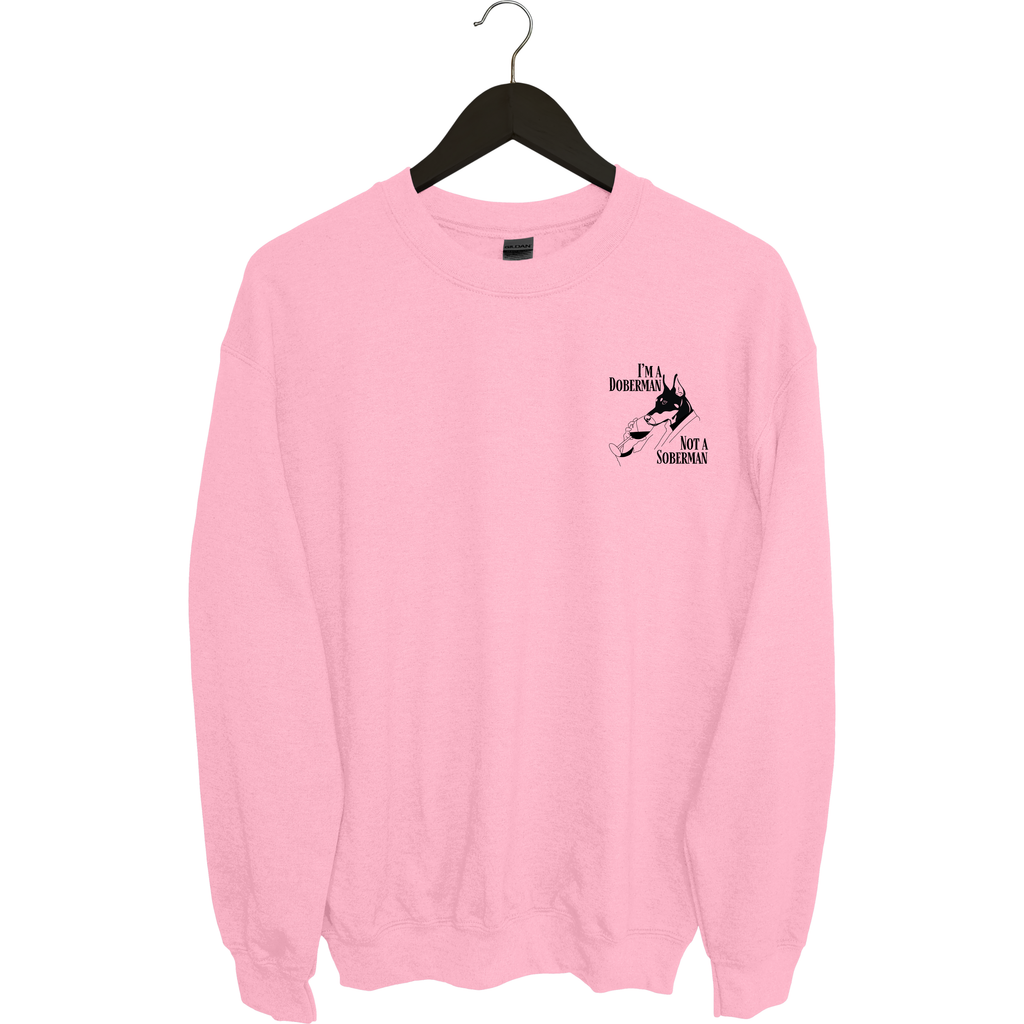 Rosafarbener Sweater auf Kleiderbügel, mit kleinem Brustmotiv eines Dobermanns mit Glas und dem Text „I’m a Doberman, not a Soberman“.